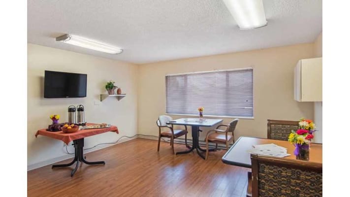 Bright common area with tables and flowers