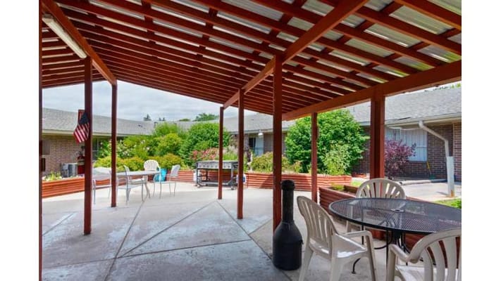 Covered outdoor space with seating in a garden area