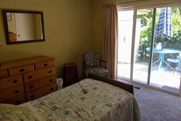 A well-furnished private resident room with a patio view.