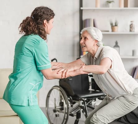 Staff assisting a resident in a bright interior space