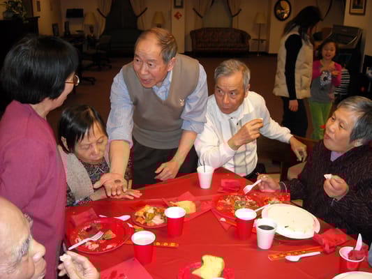 Residents enjoying a meal together at a dining table