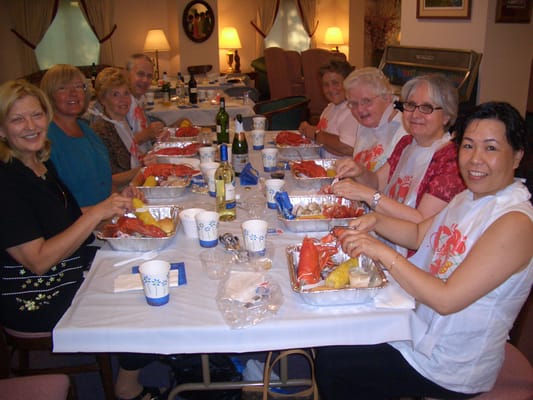 Residents enjoying a seafood feast at a communal table