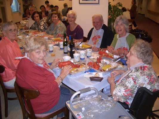 Residents enjoying a lobster dinner in a dining area