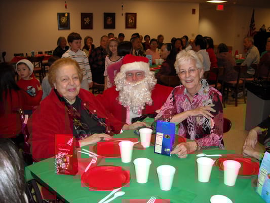 Residents celebrating with Santa Claus at a holiday event