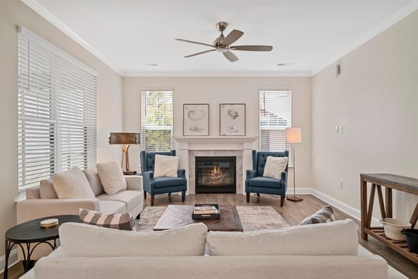 Bright common area with seating and fireplace