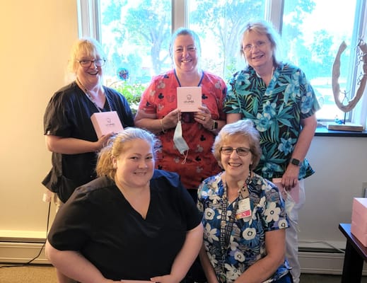 Staff members celebrating a special occasion indoors