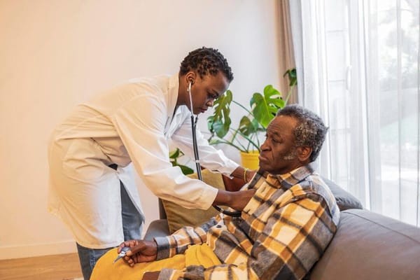 Healthcare professional attending to an elderly man