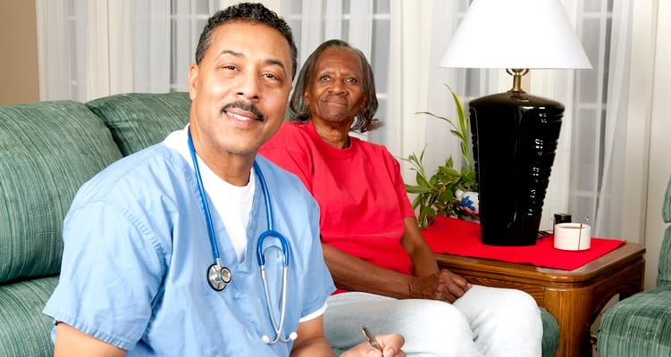 Caregiver and resident sitting in a cozy living room