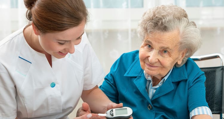 A caregiver assisting a senior resident with health monitoring