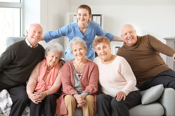 Residents and staff posing together in a common area