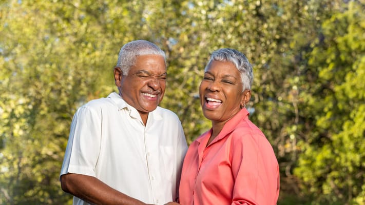 Couple enjoying a sunny day outdoors, smiling happily