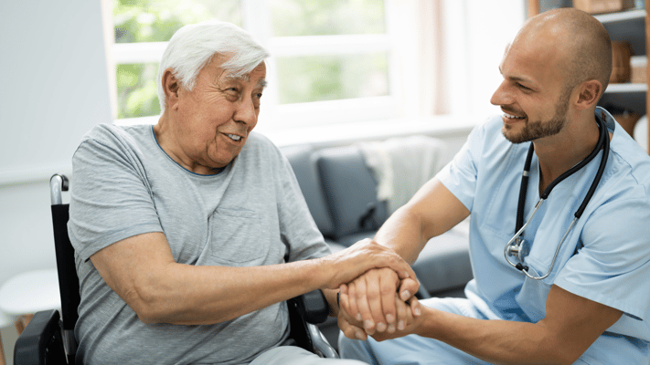 Healthcare staff interacting warmly with a resident