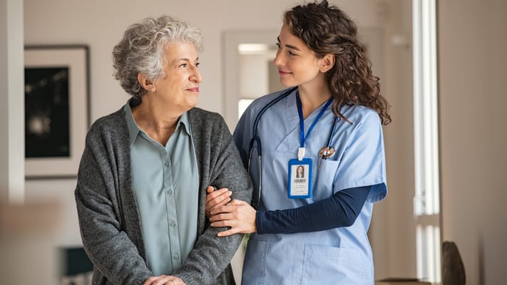 Caregiver assisting a resident in a warm facility