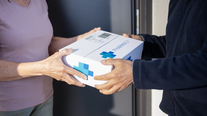 Staff delivering medication to a resident