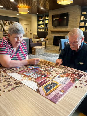 Residents enjoying a puzzle in the common area