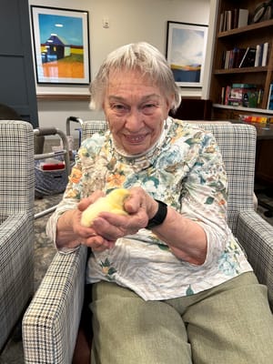 Resident smiling while holding a small object