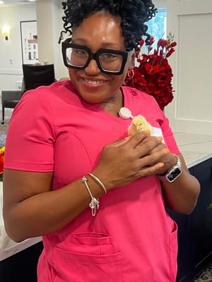 A staff member holding a chick in a bright common area
