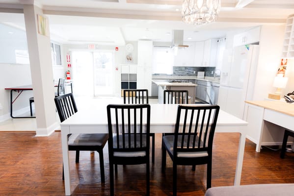 Bright common area with dining table and chairs