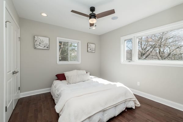Bright, well-decorated private room with a bed and artwork