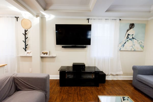 Cozy lounge area with a TV and artwork