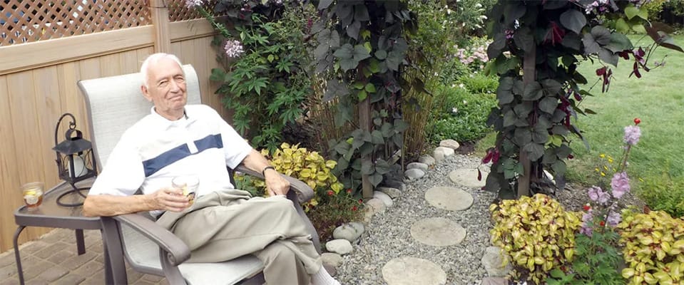An elderly man relaxing in a garden