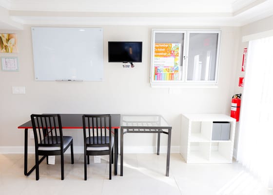 Bright, modern common area with a table and chairs