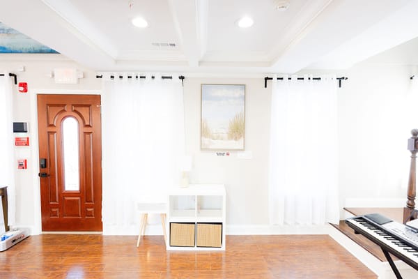 Bright interior view of a common area with piano