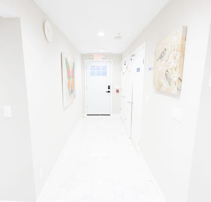 A bright corridor with artwork on the walls