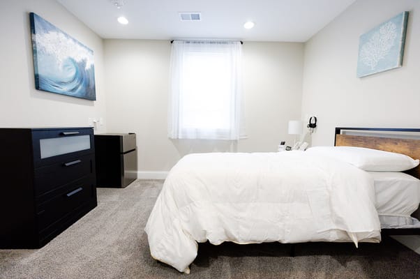 Cozy resident room with a bed and dresser