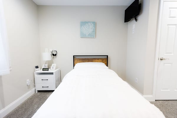 Bright private resident room with a bed and decor