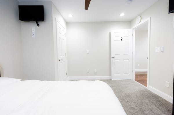 Cozy interior of a resident room with a bed and door