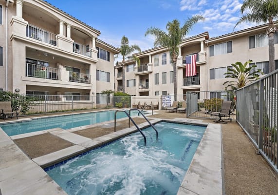 Outdoor pool and spa area adjacent to the apartments