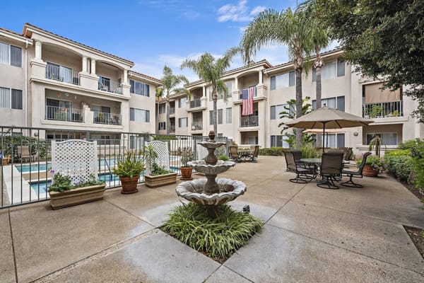 View of a landscaped outdoor common area with a fountain