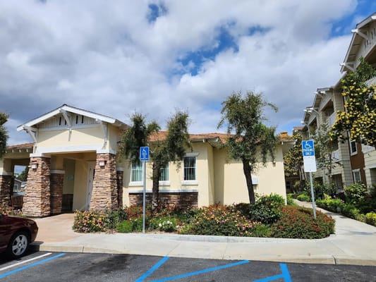Front entrance of Tyrol Plaza Senior Apartments with landscaped gardens