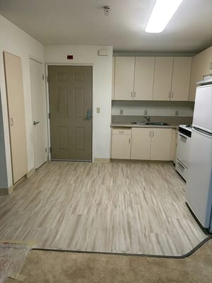 Small kitchen with cabinets and a front door