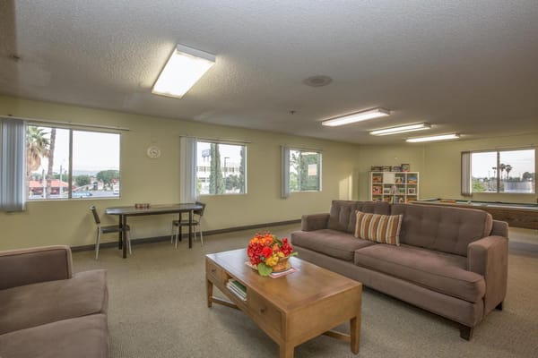 Common area with a couch and windows