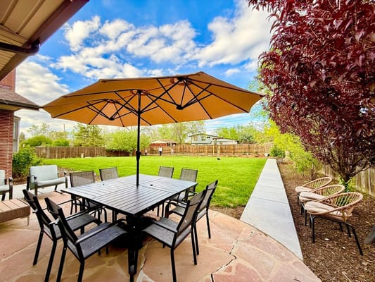 Outdoor patio with seating and a large umbrella