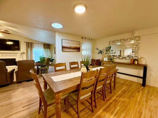 Dining area with a large wooden table and chairs