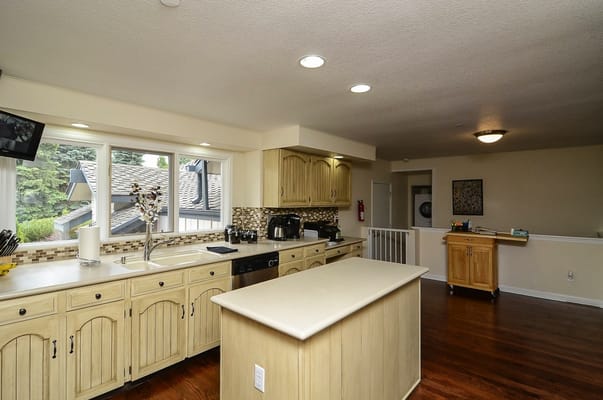 Bright kitchen with wooden cabinets and large windows