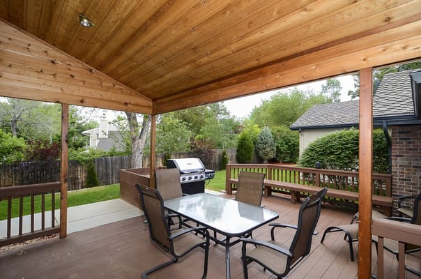 Outdoor patio with seating and grill