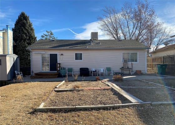 Backyard of Living with Dignity Assisted Living showing chairs and landscaping