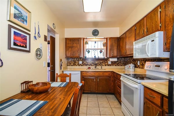 Kitchen area with wooden cabinets and dining table