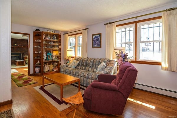 A warm living room space with a couch, chair, and decorative shelves.