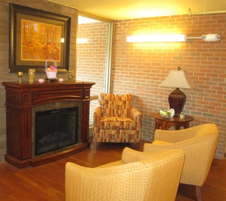Comfortable seating area with fireplace and artwork