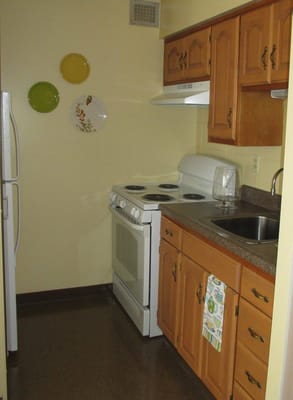 Cozy kitchen with white appliances and wooden cabinets