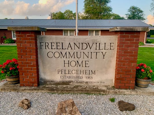 Sign for Freelandville Community Home with landscaping