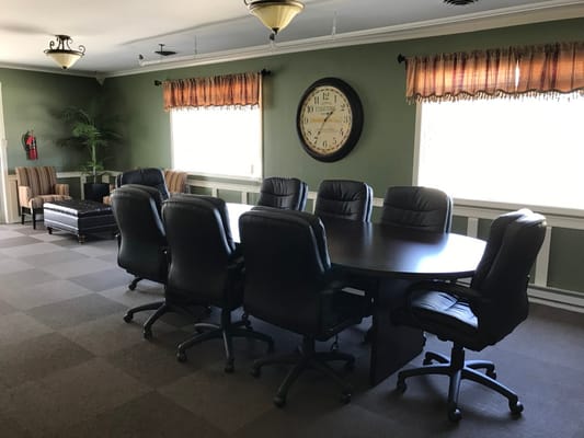 Conference room with black chairs and large round table