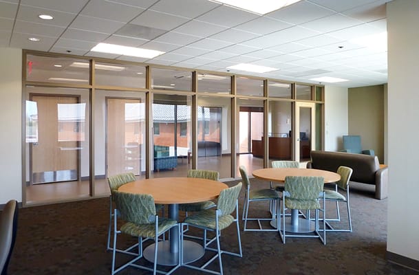Bright and spacious common area with tables and chairs