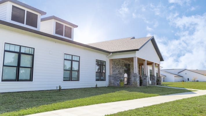 Exterior view of a senior living facility with landscaped grounds