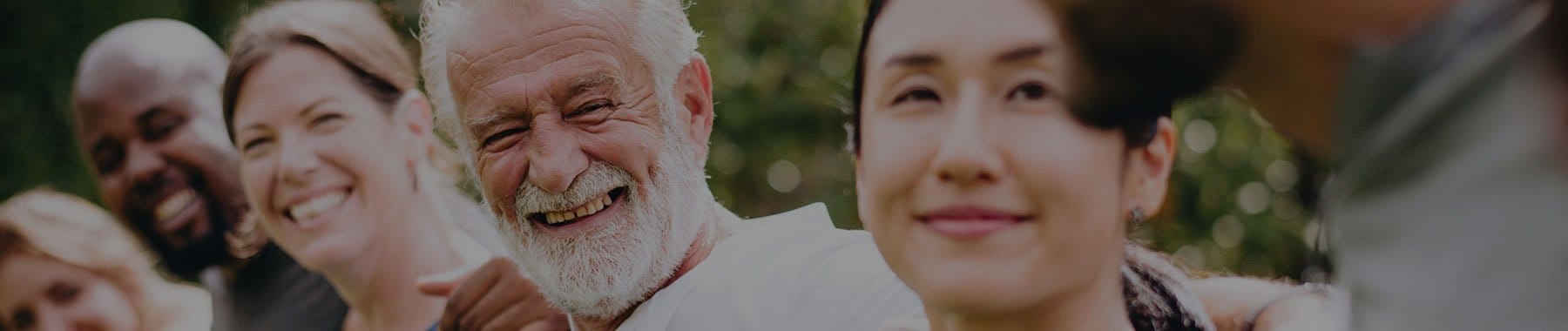 Smiling residents enjoying a social gathering outdoors